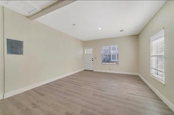 a view of kitchen with wooden floor and electronic appliances