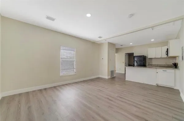a kitchen with a refrigerator and window