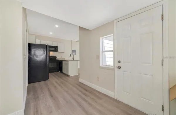 a kitchen with a refrigerator a microwave a sink and a stove