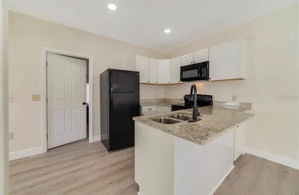 a kitchen with a refrigerator and a sink