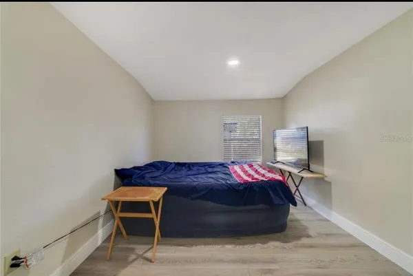 a bedroom with a bed and a window