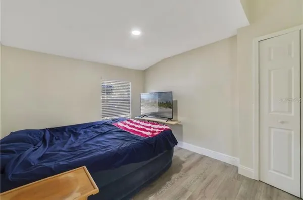a view of hallway with a closet and wooden floor