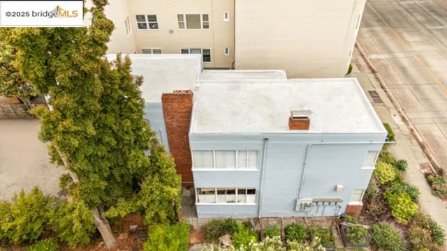 a view of a house with a yard and potted plants