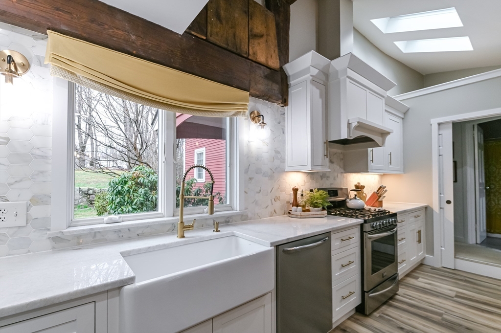 436 High Street Walpole, MA 02081 - Photo 12 of 42 a kitchen with stainless steel appliances a sink stove and cabinets