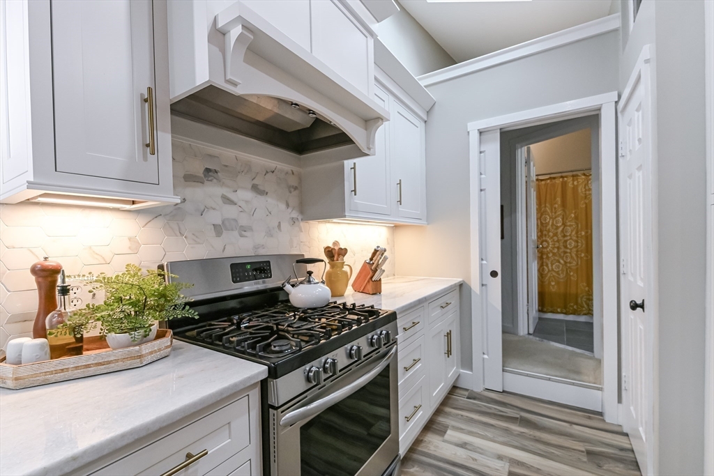 436 High Street Walpole, MA 02081 - Photo 13 of 42 a kitchen with stainless steel appliances granite countertop a stove and a refrigerator