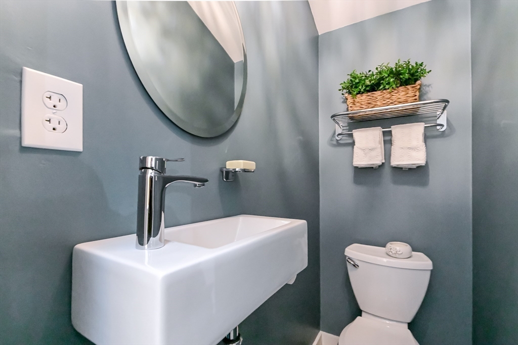436 High Street Walpole, MA 02081 - Photo 14 of 42 a bathroom with a toilet sink and mirror