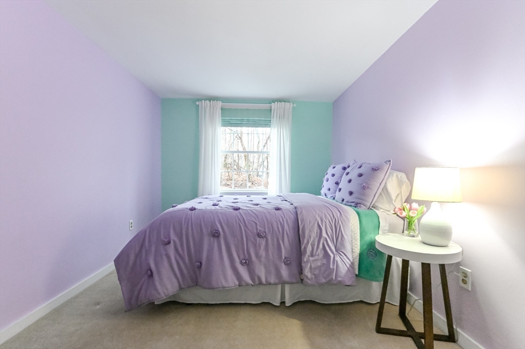436 High Street Walpole, MA 02081 - Photo 20 of 42 a bedroom with a bed and a chandelier