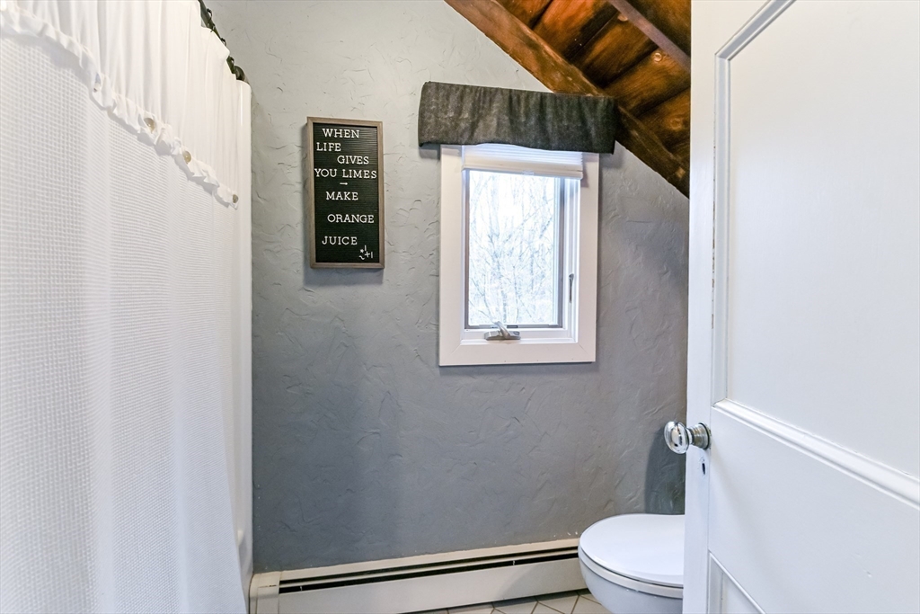 436 High Street Walpole, MA 02081 - Photo 33 of 42 a white toilet sitting next to a bathroom sink