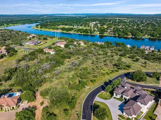 an aerial view of a house with a lake view