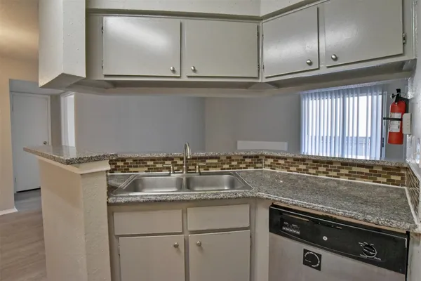 a open kitchen with a refrigerator and dishwasher