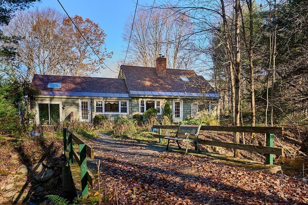 42 Cushman Road Leverett, MA 01054 - Photo 1 of 16 a front view of a house with yard porch and furniture