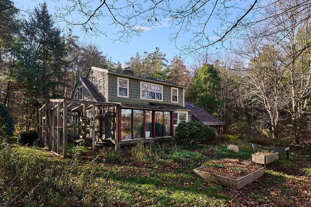 42 Cushman Road Leverett, MA 01054 - Photo 2 of 16 a view of a house with a small yard and large trees