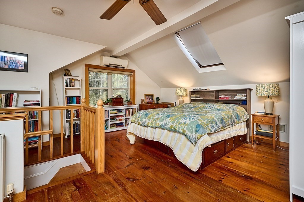 42 Cushman Road Leverett, MA 01054 - Photo 8 of 16 a bedroom with a large bed and a book shelf