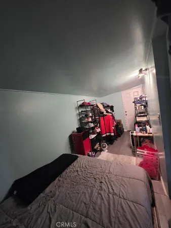 a bedroom with bed and a gym equipment