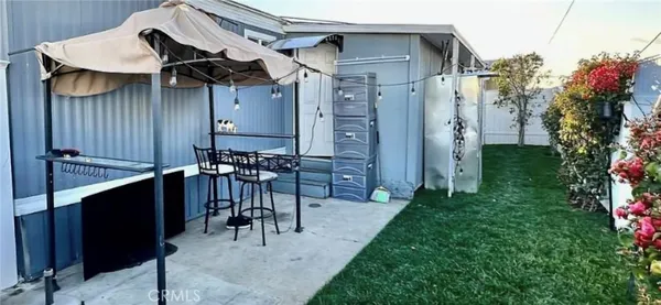 a view of a patio with table and chairs with wooden fence