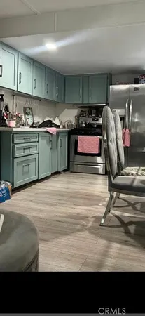 a kitchen with a refrigerator and window