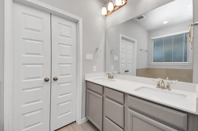 a bathroom with a shower sink and mirror