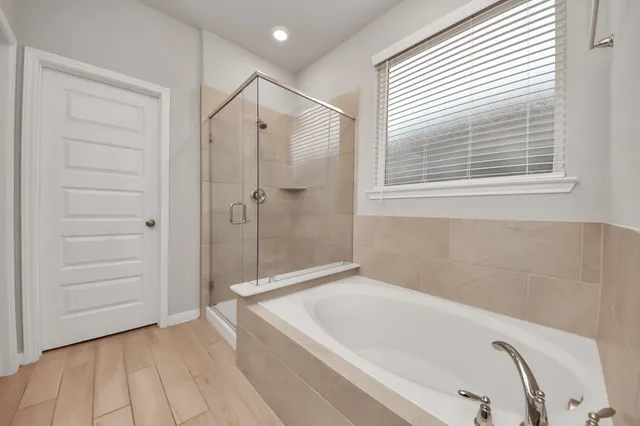 a bathroom with a bathtub and a shower