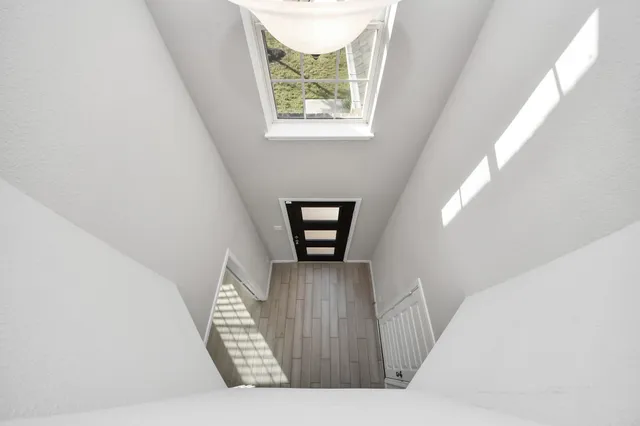 a view of staircase with wooden floor and a window