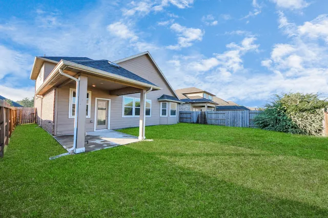 a front view of a house with yard and green space