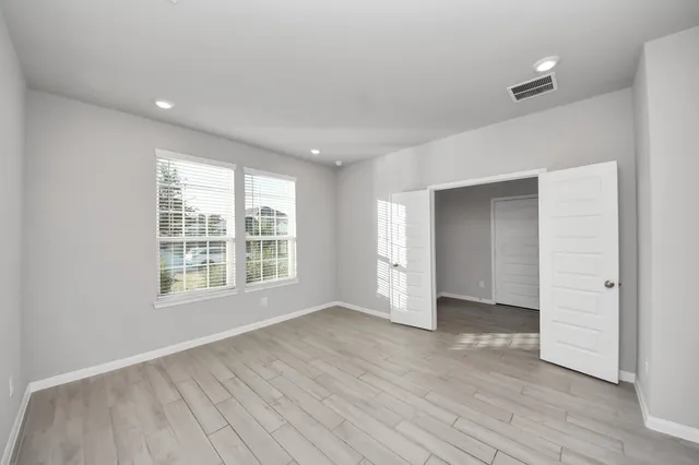 wooden floor in an empty room with a window
