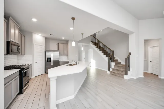 a large kitchen with a lot of counter space and refrigerator