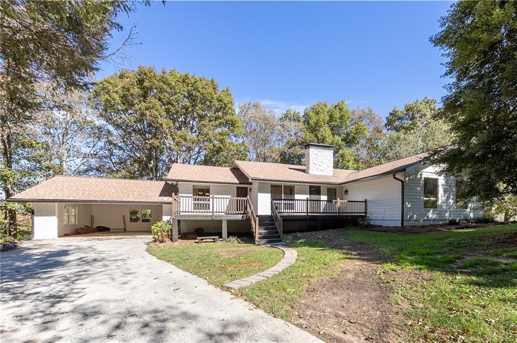 723 Bishop Road Ball Ground, GA 30107 - Photo 1 of 1 a front view of a house with a garden and trees