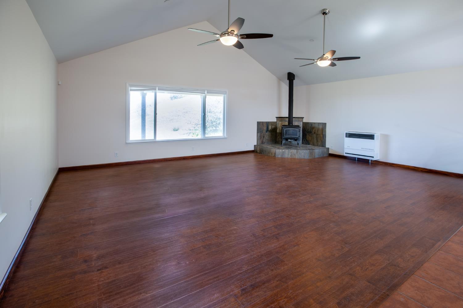 44981 Todd Eymann Road Dunlap, CA 93621 - Photo 11 of 74 a view of empty room with wooden floor and fan