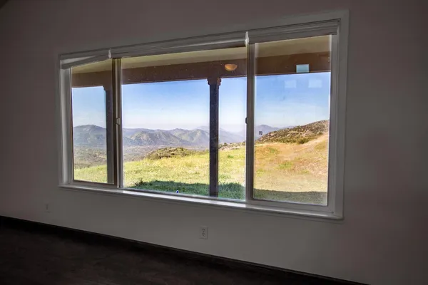 a view of room with window and ceiling fan