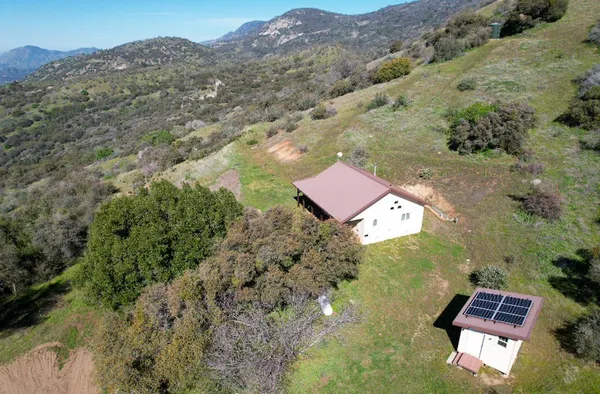 an aerial view of house with yard