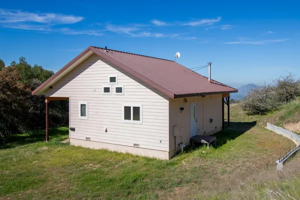 a view of a dry yard with mountains in the background