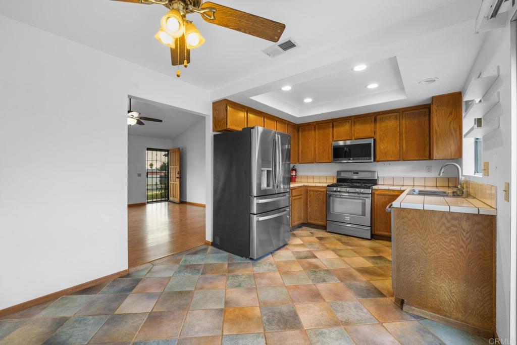 10254 Princess Joann Road Santee, CA 92071 - Photo 11 of 41 a kitchen with a refrigerator a stove top oven a sink and dishwasher