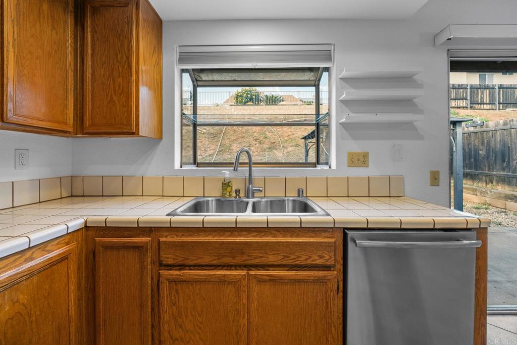 10254 Princess Joann Road Santee, CA 92071 - Photo 14 of 41 a kitchen with granite countertop cabinets sink and window