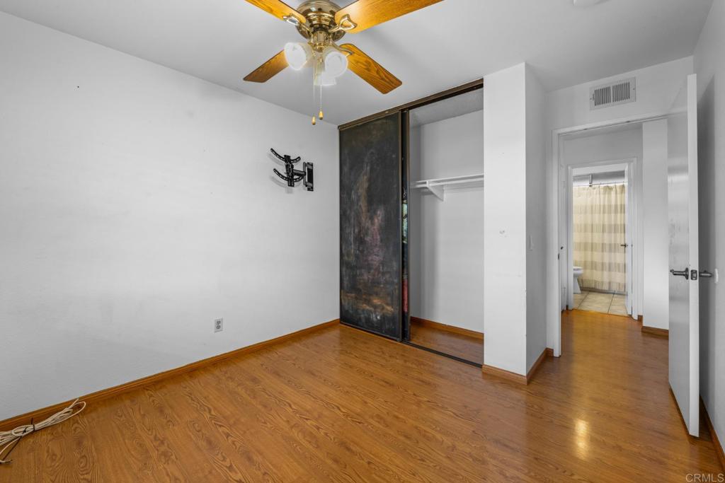 10254 Princess Joann Road Santee, CA 92071 - Photo 18 of 41 a view of an empty room with closet and a chandelier fan