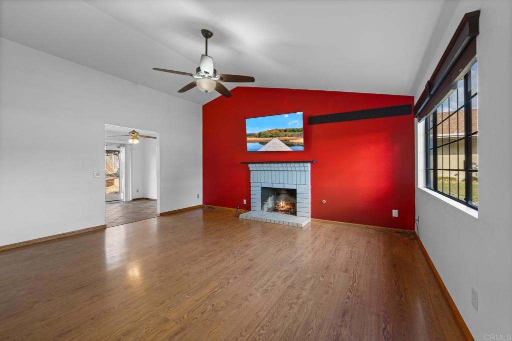 10254 Princess Joann Road Santee, CA 92071 - Photo 2 of 41 a view of an empty room with wooden floor fireplace and a window