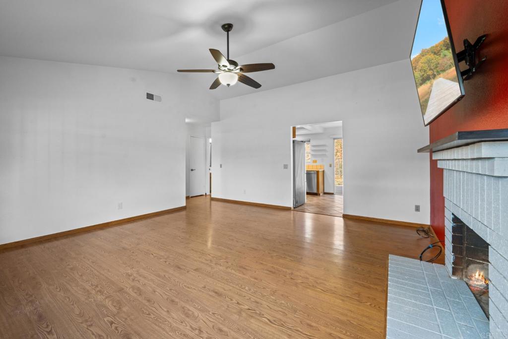10254 Princess Joann Road Santee, CA 92071 - Photo 3 of 41 a view of empty room with wooden floor and fan