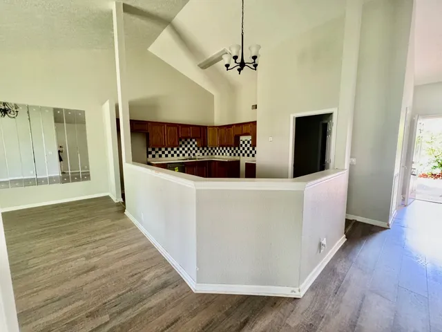 a view of a room with wooden floor