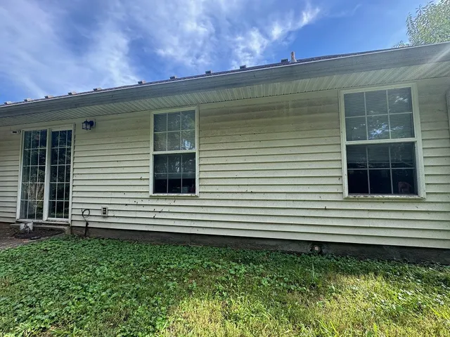 a side view of a house with a yard