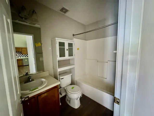 a bathroom with a sink toilet tub and shower