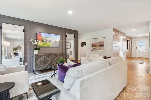 a living room with furniture and a flat screen tv
