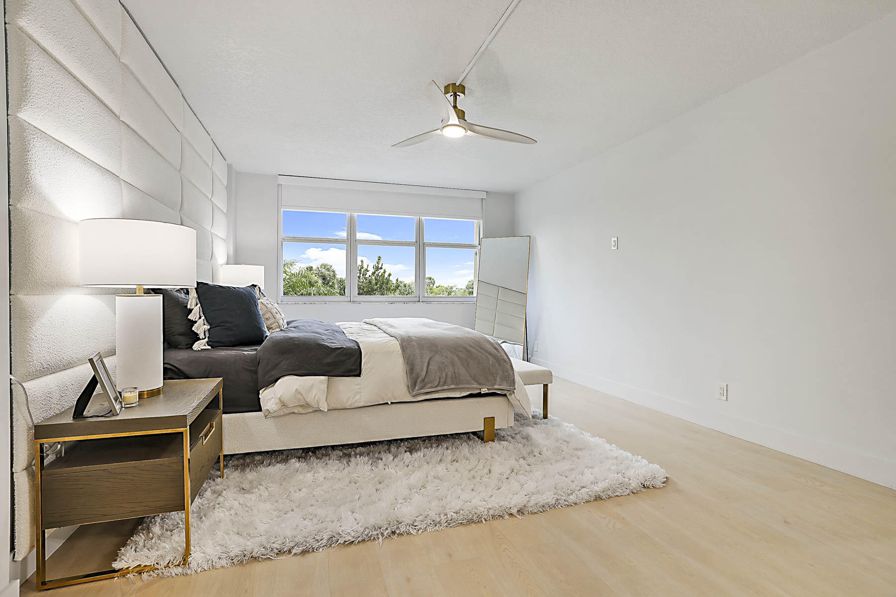 2121 North Ocean Boulevard, Unit 305W Boca Raton, FL 33431 - Photo 17 of 75 a bedroom with a bed and lamp