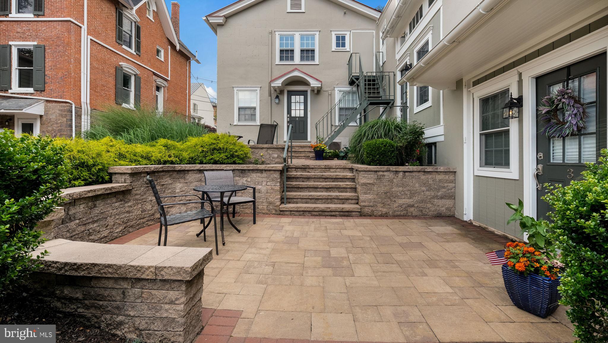 112 East State Street, Unit 6 Doylestown, PA 18901 - Photo 12 of 13 a front view of a house with outdoor seating and barbeque oven