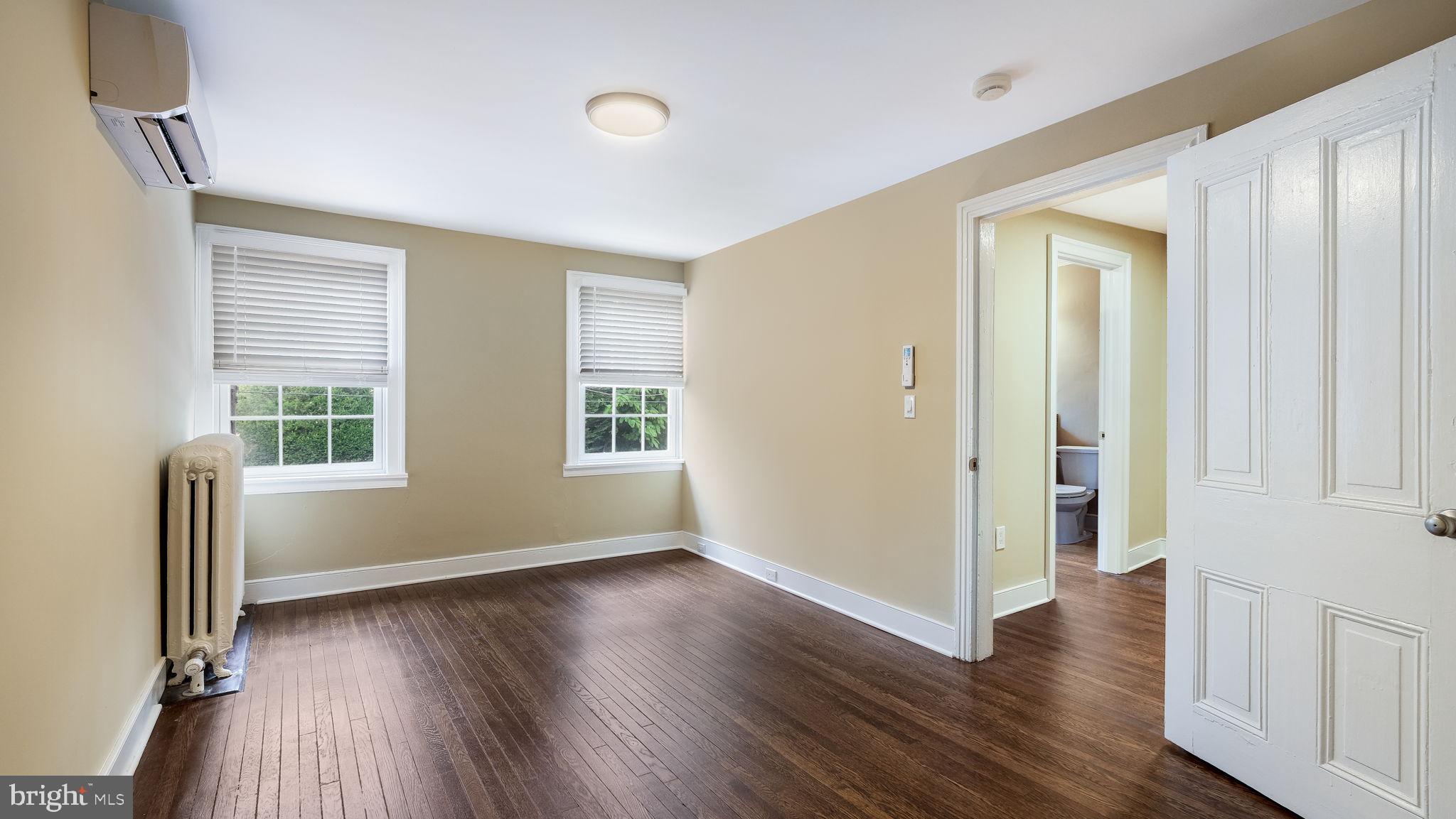 112 East State Street, Unit 6 Doylestown, PA 18901 - Photo 5 of 13 an empty room with wooden floor and windows