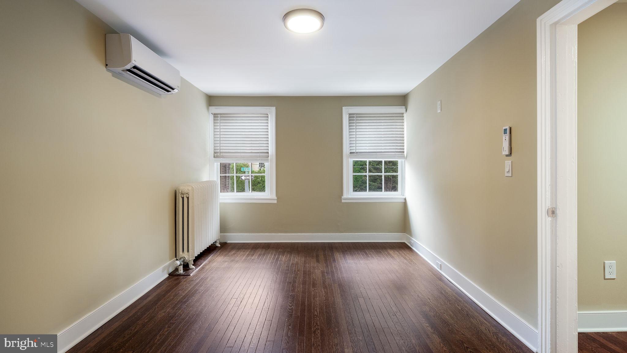 112 East State Street, Unit 6 Doylestown, PA 18901 - Photo 6 of 13 an empty room with wooden floor and windows