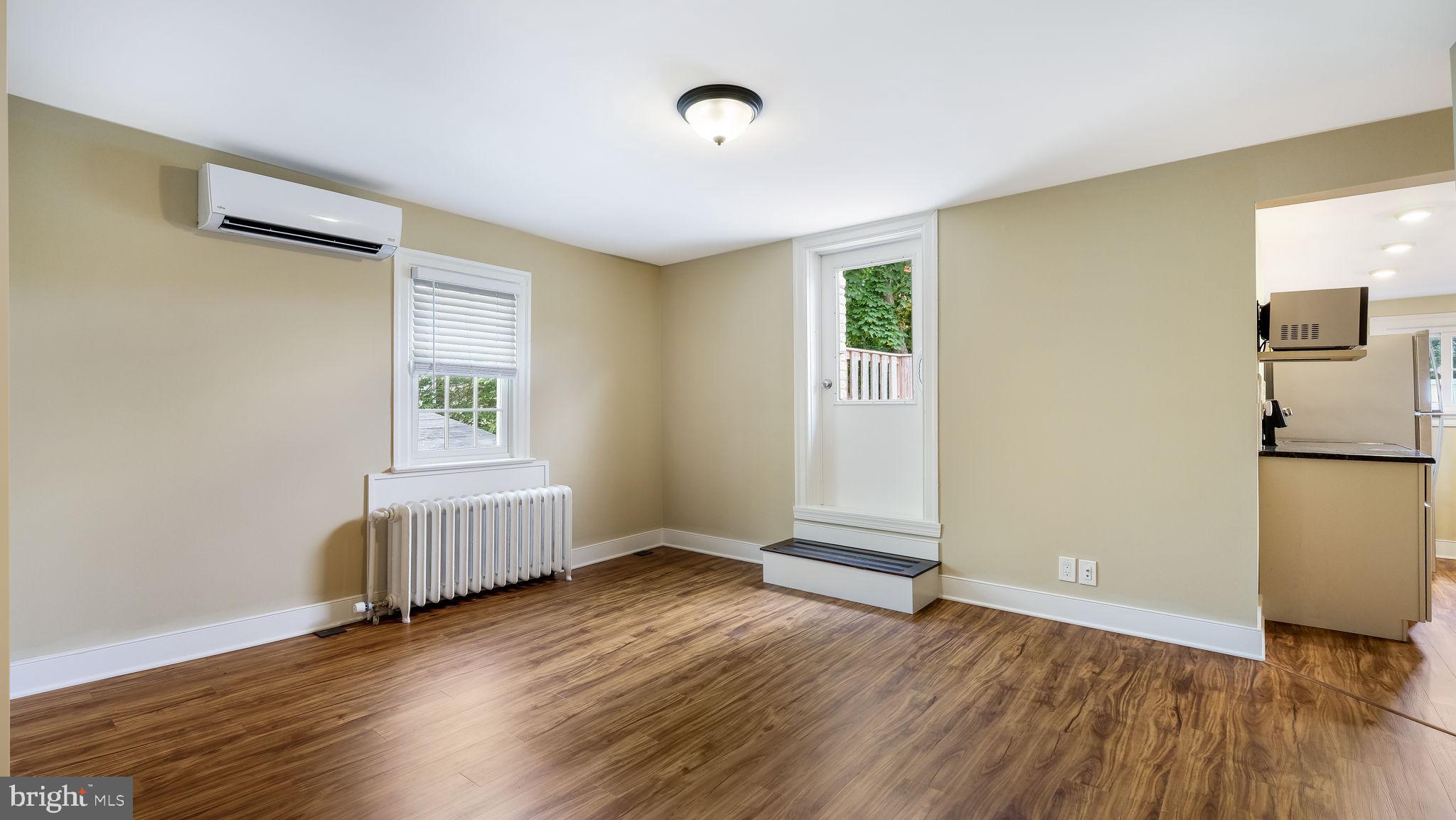 112 East State Street, Unit 6 Doylestown, PA 18901 - Photo 9 of 13 an empty room with wooden floor and a window