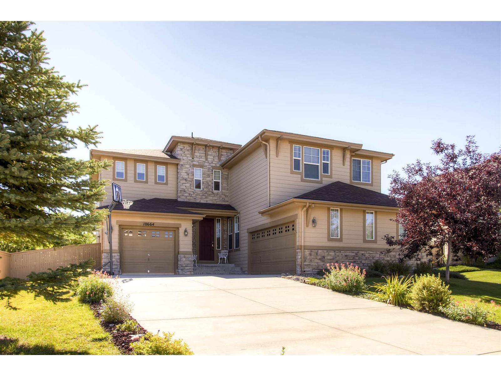 10664 Chandon Place Highlands Ranch, CO 80126 - Photo 1 of 1 a front view of a house with a yard and garage