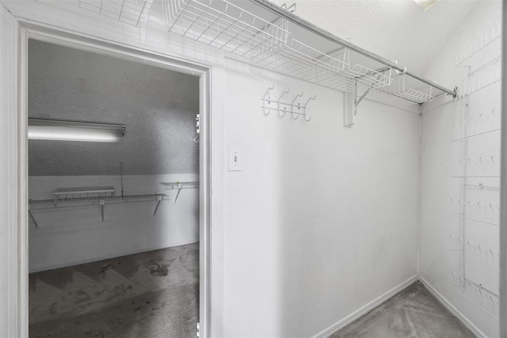 5590 Spring Valley Road, Unit H 203 Dallas, TX 75254 - Photo 26 of 27 Walk-in closet featuring wire shelving, a hanging rod, and wall-mounted hooks