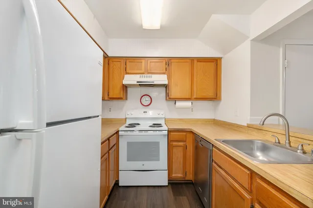 a kitchen with a sink stove and refrigerator