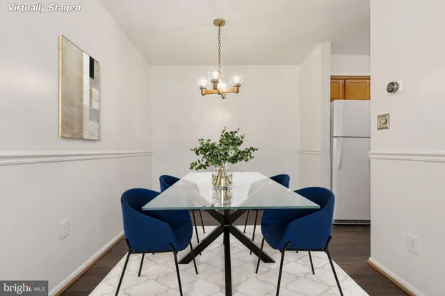 a dining room with furniture and chandelier