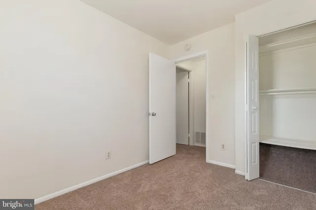 an empty room that has a mirror in it